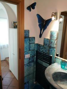 特雷维尼亚诺罗马诺Villa Fonte Tartaruga Trevignano Romano的浴室墙上挂着蝴蝶