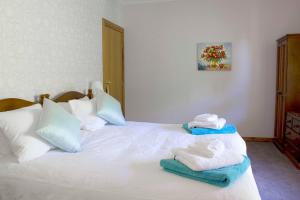 麦克拉伦谷蒂凡尼住宿加早餐旅馆的卧室配有白色床和毛巾