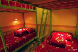 北港镇北港好住背包客棧的红色床单的客房内的两张双层床