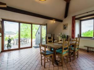 WalcourtSpacious Farmhouse in Fontenelle with Garden的一间带木桌和椅子的用餐室