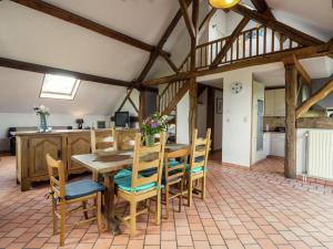 WalcourtSpacious Farmhouse in Fontenelle with Garden的厨房以及带木桌和椅子的用餐室。