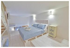 莫诺波利Dimora Barone的一间卧室配有一张带蓝色床单的床和床头柜。