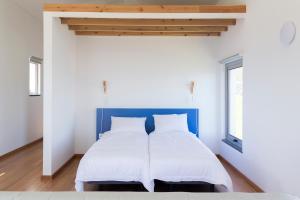 Lofts Azul Pastel客房内的一张或多张床位
