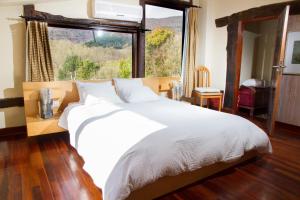 宏达瑞比亚paperkienea - artandrelax的一间卧室设有一张大床和一个大窗户