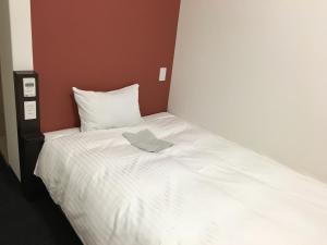 增田瑞穗石见增田旅馆的一张白色的床,上面有一条毛巾