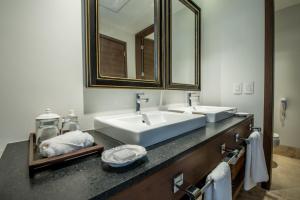 瓜达拉哈拉Square Small Luxury Hotel - Providencia的一间带两个盥洗盆和大镜子的浴室
