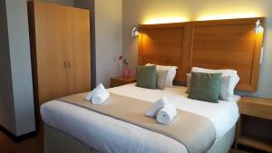 阿姆斯特丹班克酒店的一间卧室配有一张大床和毛巾