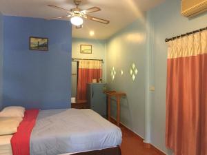 穆克莱克ฺฺ班应考度假村 的一间卧室配有一张床和吊扇