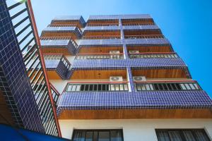 雅卡雷伊Hotel Brisa Rio的一座高大的建筑,上面有蓝色的太阳能电池板