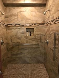 卡利斯托加Golden Haven Hot Springs的带淋浴的浴室(带石墙)