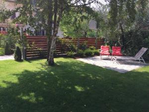 加尔达湖滨Casa Ducati的两把红色椅子坐在树下,在院子里