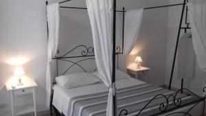 罗马Apartment Ostiense Piramide Station的一间卧室配有一张带两盏灯的黑色天蓬床