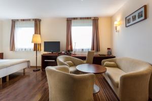 格利维采格利维采酷步酒店的酒店客房带椅子、床和桌子