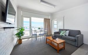 阿勒达拉海港景公寓的客厅配有沙发和桌子