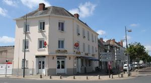 圣皮耶尔代科尔普Hotel Restaurant l'Avenir的街道拐角处的白色大建筑