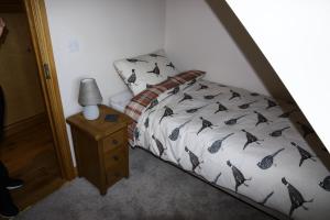 根斯堡Thonock lane lodge的一间卧室配有一张床和一张带台灯的桌子