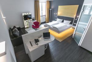 辛斯海姆辛斯海姆酒店的一间卧室配有一张床和一张带笔记本电脑的书桌
