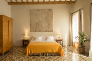 马翁哈迪德赛斯布鲁克斯精品酒店的卧室配有一张床,墙上挂有绘画作品
