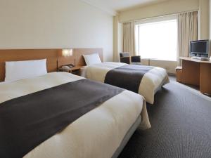 
北九州皇冠饭店客房内的一张或多张床位
