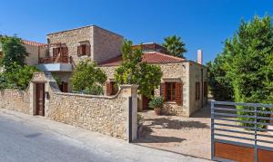 阿斯特里昂Amazing Villas in Crete的一座石墙和围栏的房子