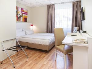 柏林金郁金香克佩尼克北欧酒店 的配有一张床和一张书桌的酒店客房