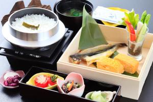 水上町米卡萨日式旅馆的一张桌子,上面有三盒饭和米饭