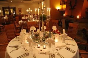 代特莫尔德兰德豪斯希尔施普龙旅馆的餐桌,配有白色桌布和蜡烛