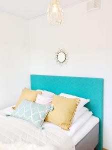 拉赫蒂Lahti Center Design Apartment Uno的一张带枕头的蓝色床头板的床