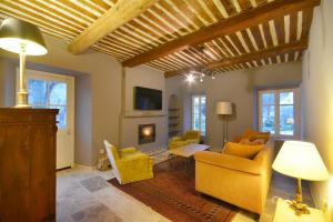 埃加利埃Ancien Mas Du Moulin的客厅配有黄色家具和壁炉