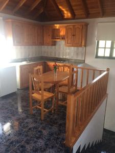 埃尔帕索Casa Antigua的厨房配有木桌、椅子和柜台