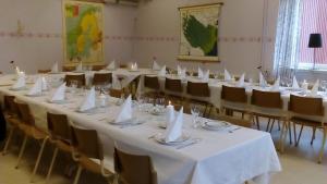 Väster GafseleGafsele Lappland Hostel的一间设有白色桌椅和白色餐巾的房间