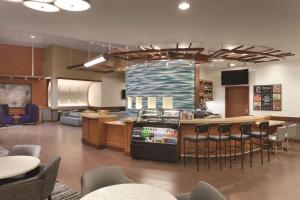 波特兰波特兰机场/喀斯喀特车站君悦酒店的一间带酒吧、椅子和厨房的餐厅
