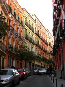 马德里阿尔玛套房公寓的一条城市街道,汽车停在建筑前
