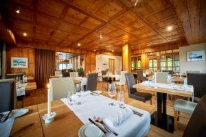 贝尔瓦尔德翁雅度假Spa酒店的餐厅设有木制天花板和桌椅
