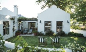埃尔金Vredenhof Farm Cottage的院子里带椅子的白色房子