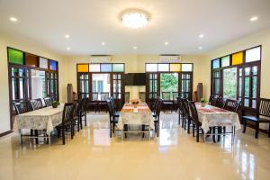 安帕瓦安帕瓦精品度假酒店的用餐室设有桌椅和窗户。