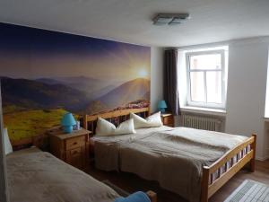 RodershausenEifel Ferienhaus Rodershausen的一间卧室设有两张床,墙上挂着一幅画
