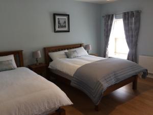 查尔斯敦Cornerstone 2 Bed Townhouse的一间卧室设有两张床和窗户。