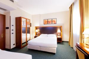 罗马罗马西平顺酒店 的酒店客房,设有两张床和镜子