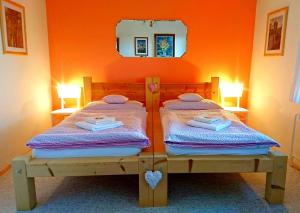 纳霍德博尔住宿加早餐旅馆的橙色墙壁的客房内的两张床