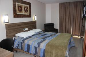 Hotel do Comércio客房内的一张或多张床位