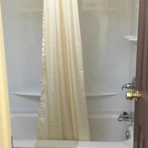 ChanuteGuest House Motel Chanute的浴室内配有淋浴帘。