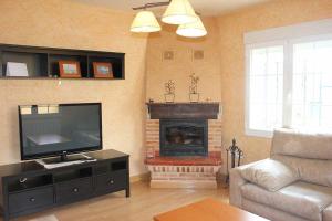 AnguixLa Verdevilla的客厅设有壁炉和平面电视。