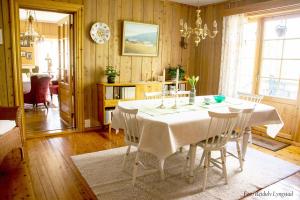 RendalenBakken Gårdshus的一间配备有白色桌椅的用餐室