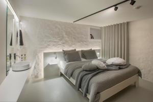 根特斯诺兹爱普假日&商务公寓的一间卧室设有一张带石墙的大床