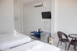 亚兰OB-Oon Resort的一间酒店客房,设有两张床、一张桌子和一台电视机