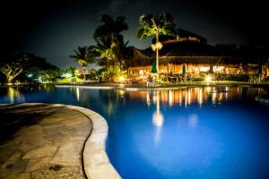 安格拉杜斯雷斯Hotel do Bosque ECO Resort的棕榈树和建筑的游泳池