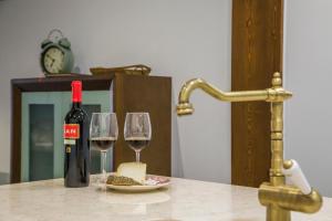 圣马特奥Apartament Rural El Rellotge的桌子上放有一瓶葡萄酒和两杯酒