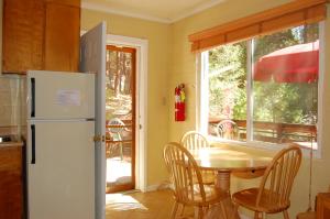 瓦沃纳65 Sparrows Nest的厨房配有桌子和白色冰箱。