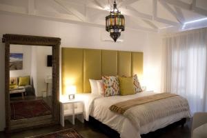 鲸湾港雷兹旅馆的一间卧室配有一张大床和镜子